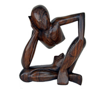 Wooden figure leaning on its right hand